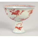 A CHINESE CORAL RED, BLUE AND WHITE PORCELAIN STEM CUP, painted with various beasts, bearing six-