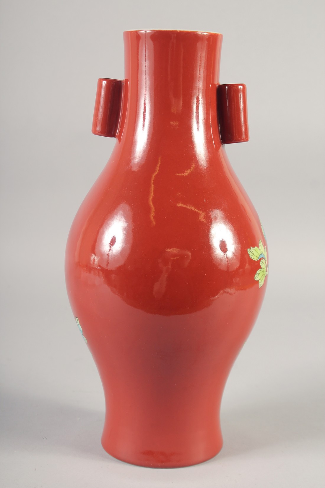 A CHINESE RED GROUND PORCELAIN TWIN HANDLE VASE, painted with flora, six-character mark to base, - Image 3 of 6