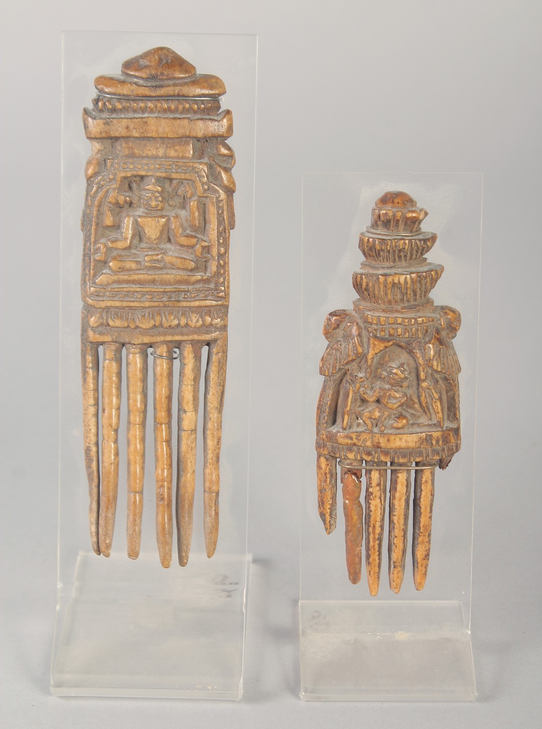 TWO 16TH-17TH CENTURY SOUTH INDIAN CARVED BONE COMBS, 13cm and 10.5cm, (2).