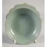 A CHINESE CELADON BOWL / CUP, with molded handle, 17.5cm wide.