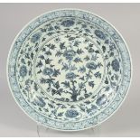 A LARGE CHINESE BLUE AND WHITE PORCELAIN CHARGER, decorated with flowers and scrolling vine, 45cm