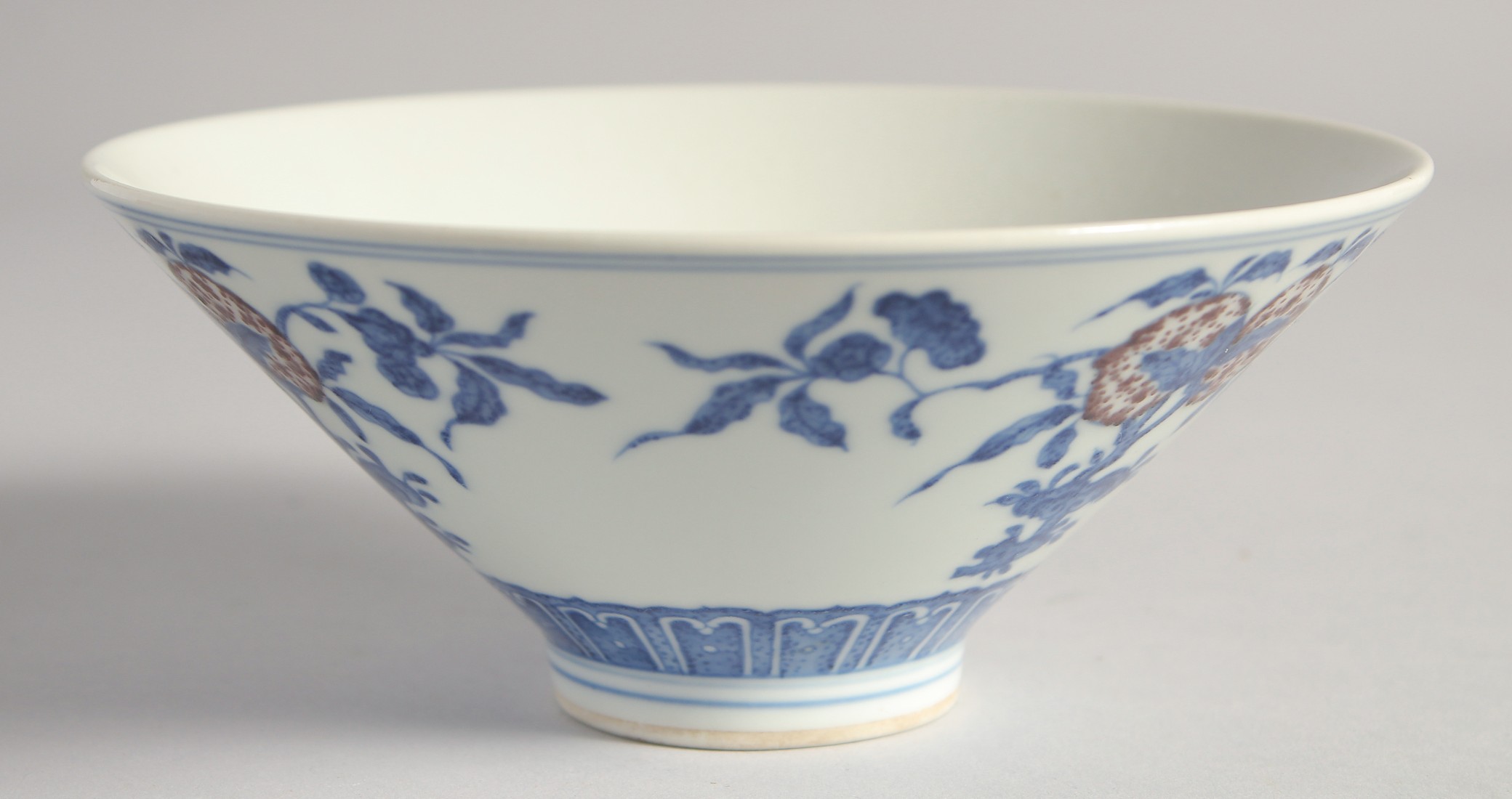 A CHINESE BLUE, WHITE AND UNDERGLAZE RED PORCELAIN BOWL, painted with pomegranate, 16cm diameter.