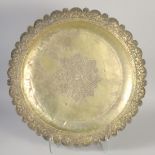 A LARGE ISLAMIC METAL TRAY, with embossed foliate rim, 54cm diameter.