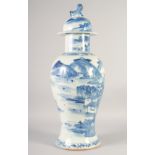 A LARGE CHINESE BLUE AND WHITE PORCELAIN VASE AND COVER, painted with an ox crossing a bridge within