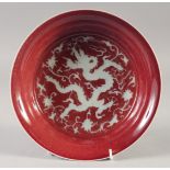 A CHINESE IRON RED PORCELAIN BOWL, with central white dragon, the base with six-character mark, 22cm