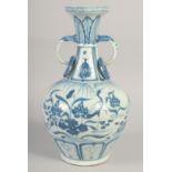 A CHINESE BLUE AND WHITE PORCELAIN TWIN HANDLE VASE, the handles formed as elephants, 35.5cm high.