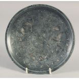 A SMALL ISLAMIC MIXED METAL DISH, decorated with fish, 16.5cm diameter.