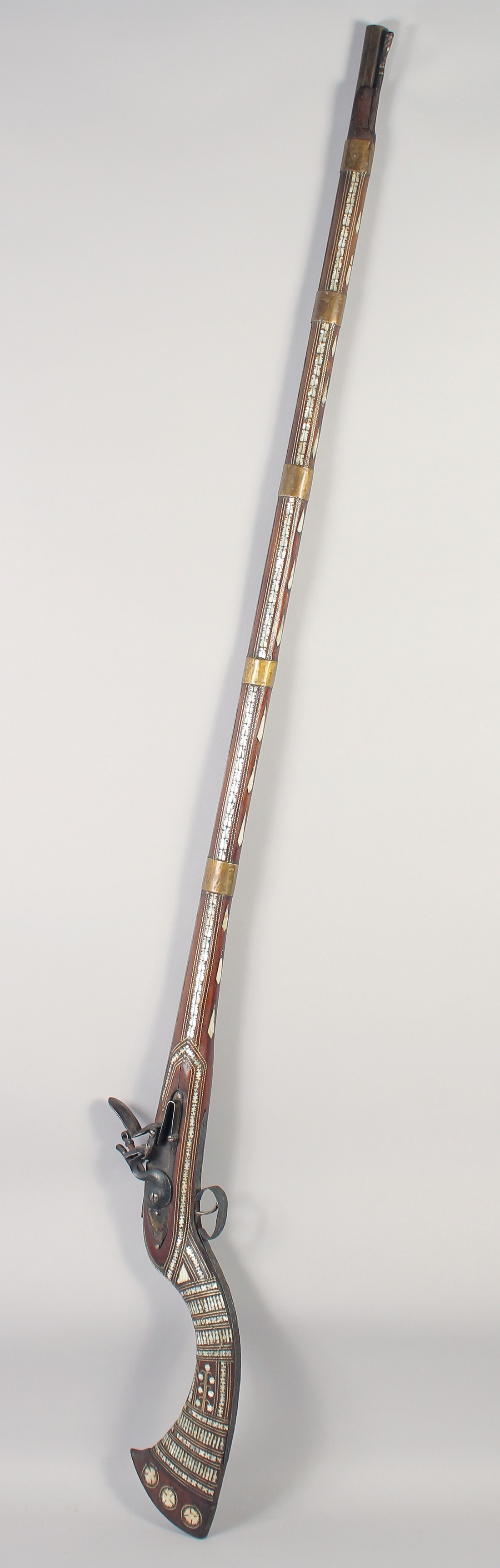 A 19TH CENTURY AFGHAN JEZAIL MOTHER OF PEARL INLAID FLINKLOCK RIFLE, 167cm long.