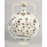 A CHINESE UNDER GLAZE RED AND WHITE TWIN HANDLE MOON FLASK, decorated with flora, 28.5cm high.