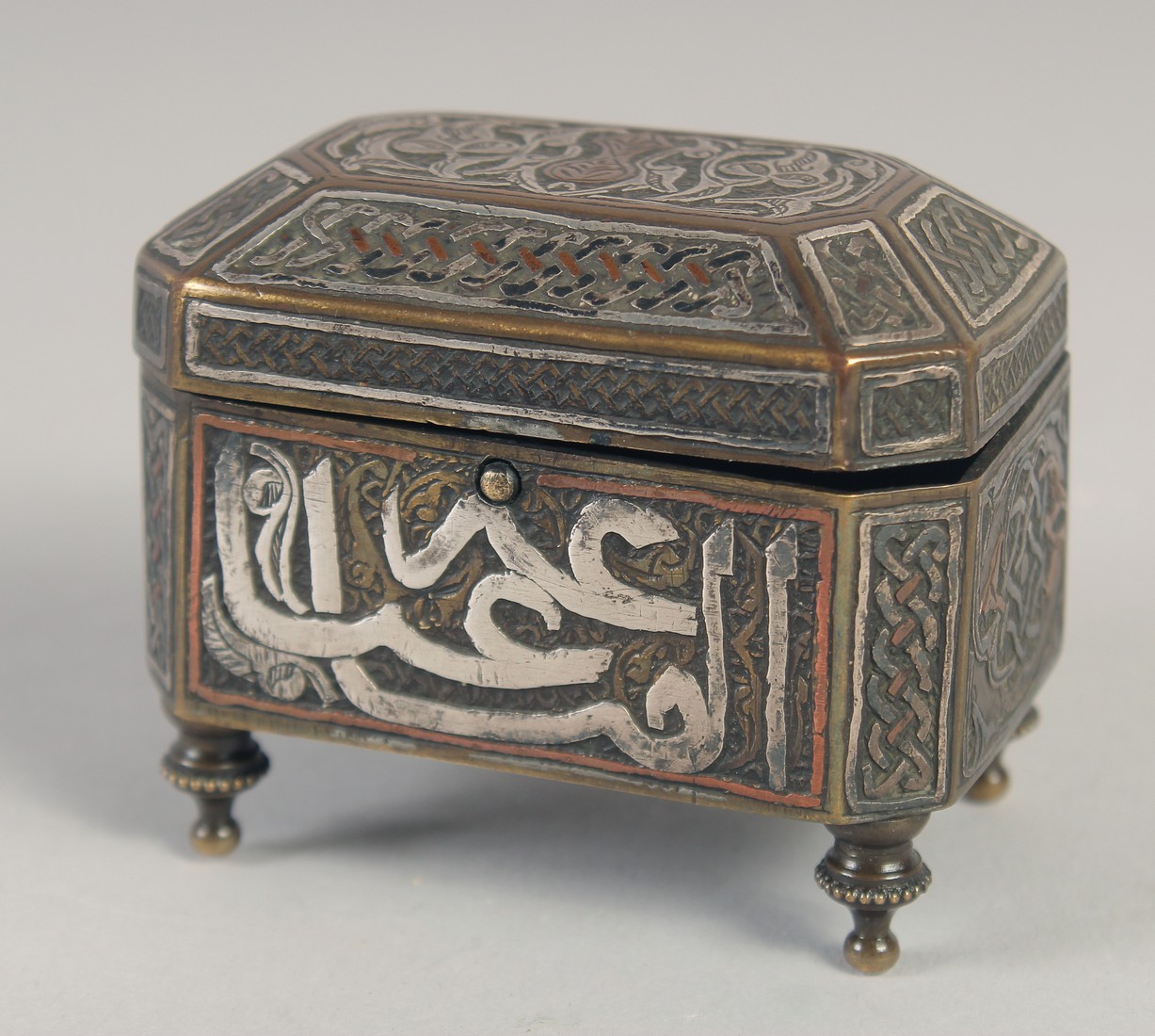 A SYRIAN MINIATURE BRASS BOX, with hinged lid, 7cm x 4.5cm.