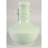 A CHINESE CELADON TWIN HANDLE VASE, with carved decoration, six-character mark to base, 24cm high.
