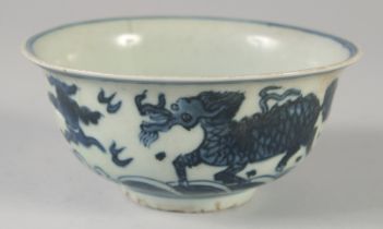 A CHINESE BLUE AND WHITE PORCELAIN BOWL, painted with beasts / animals, (af), 14cm diameter.