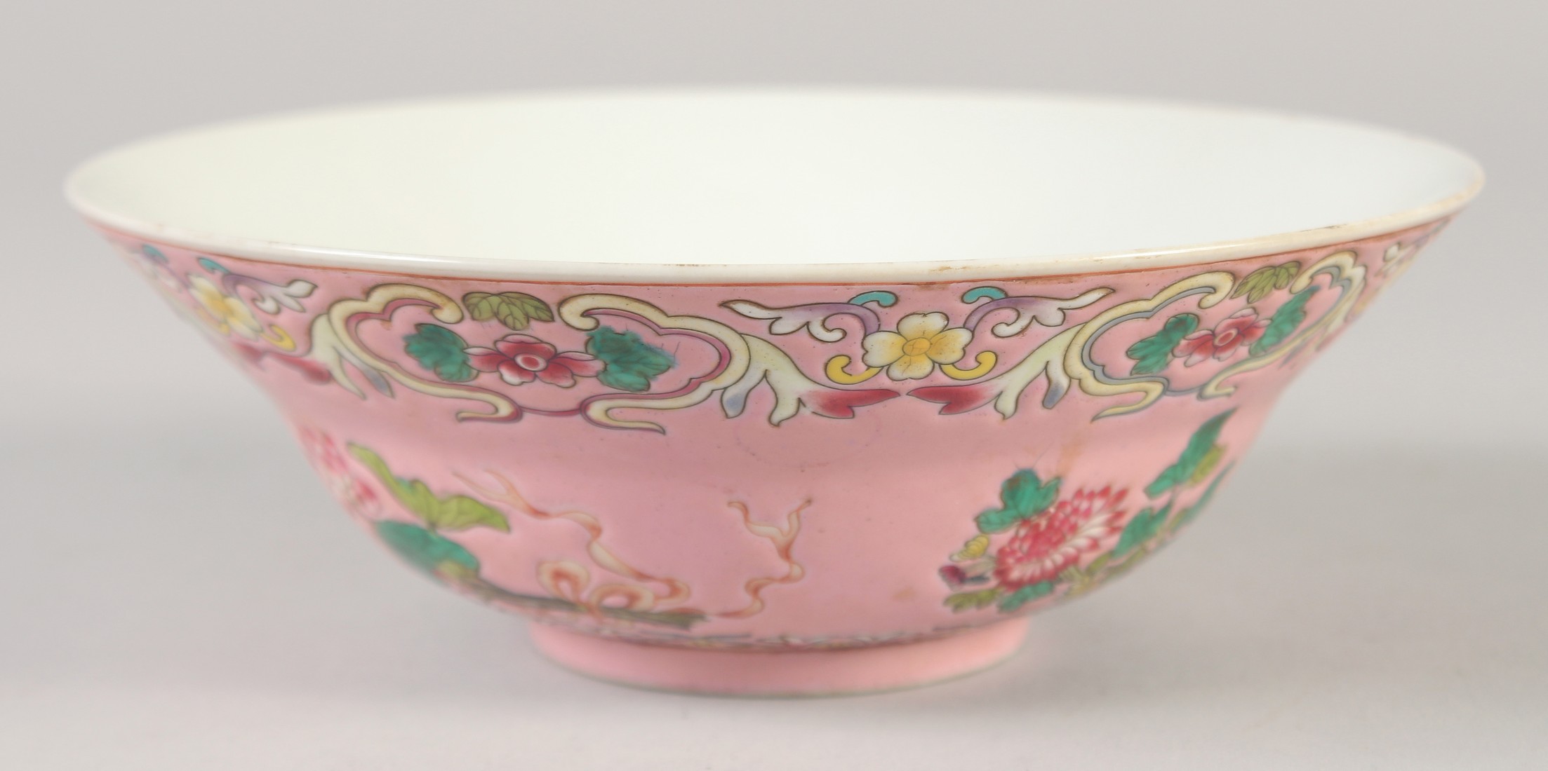 A CHINESE FAMILLE ROSE PORCELAIN BOWL, decorated with flora, the interior with five bats, four-