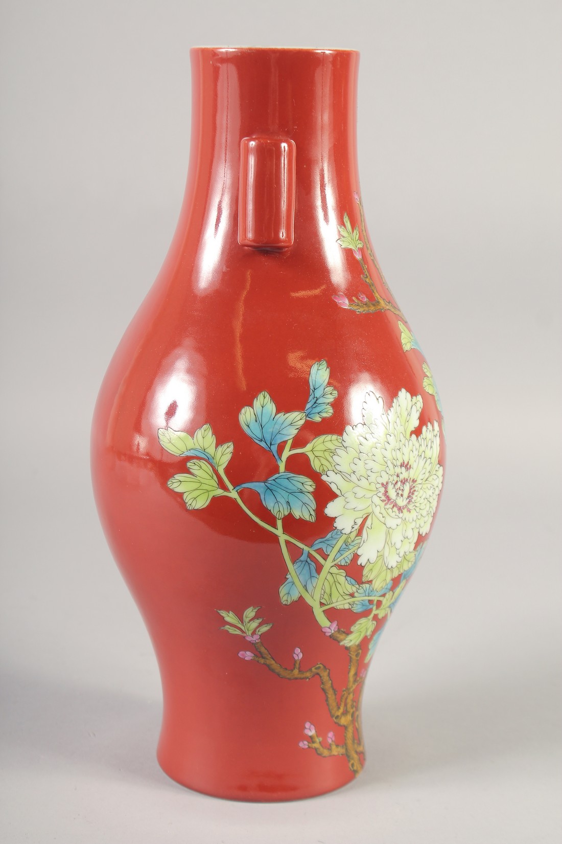 A CHINESE RED GROUND PORCELAIN TWIN HANDLE VASE, painted with flora, six-character mark to base, - Image 2 of 6