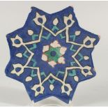 AN ISLAMIC GLAZED POTTERY STAR TILE, with foliate star form motif decoration, 24.5cm at widest