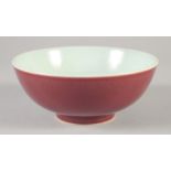 A CHINESE COPPER RED GLAZE PORCELAIN BOWL, incised character mark to base, 17.5cm diameter.