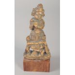 A 17TH CENTURY SOUTH INDIAN CARVED BONE FIGURE of fluting Krishna, mounted to a wooden base, carving