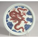 A CHINESE BLUE AND UNDERGLAZE RED PORCELAIN DRAGON DISH, 30cm diameter.