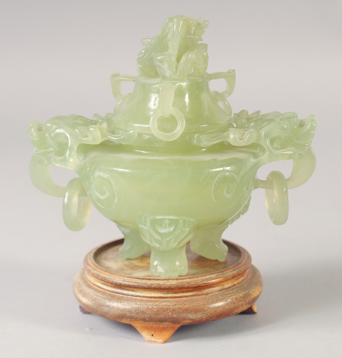 A CARVED JADE KORO AND COVER, with drop ring handles, together with hardwood stand.