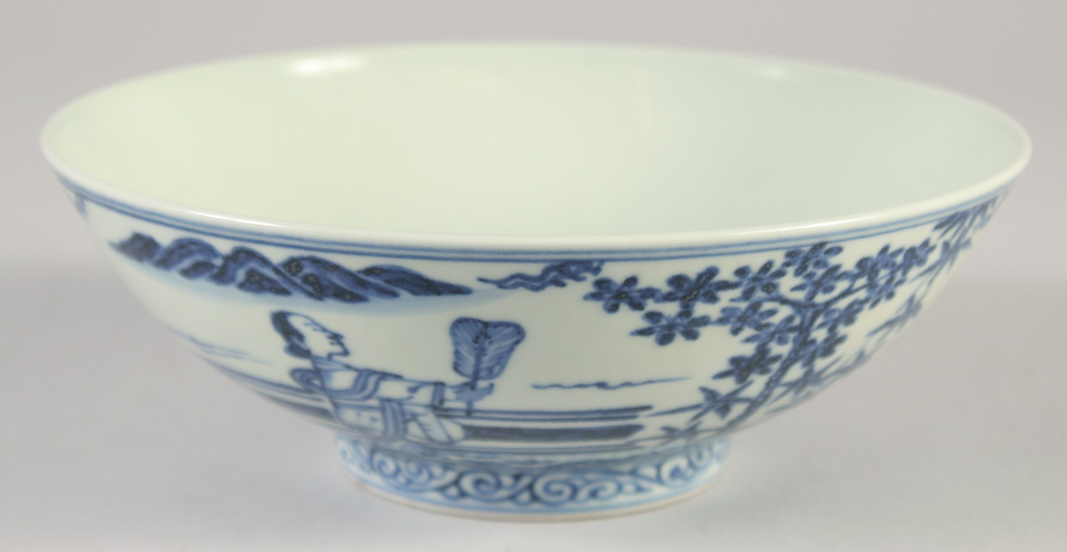A CHINESE BLUE AND WHITE PORCELAIN BOWL, decorated with figures, four-character mark to base, 19cm