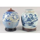 TWO CHINESE BLUE AND WHITE PORCELAIN JARS AND COVERS, each on fitted hardwood stands, 26cm and