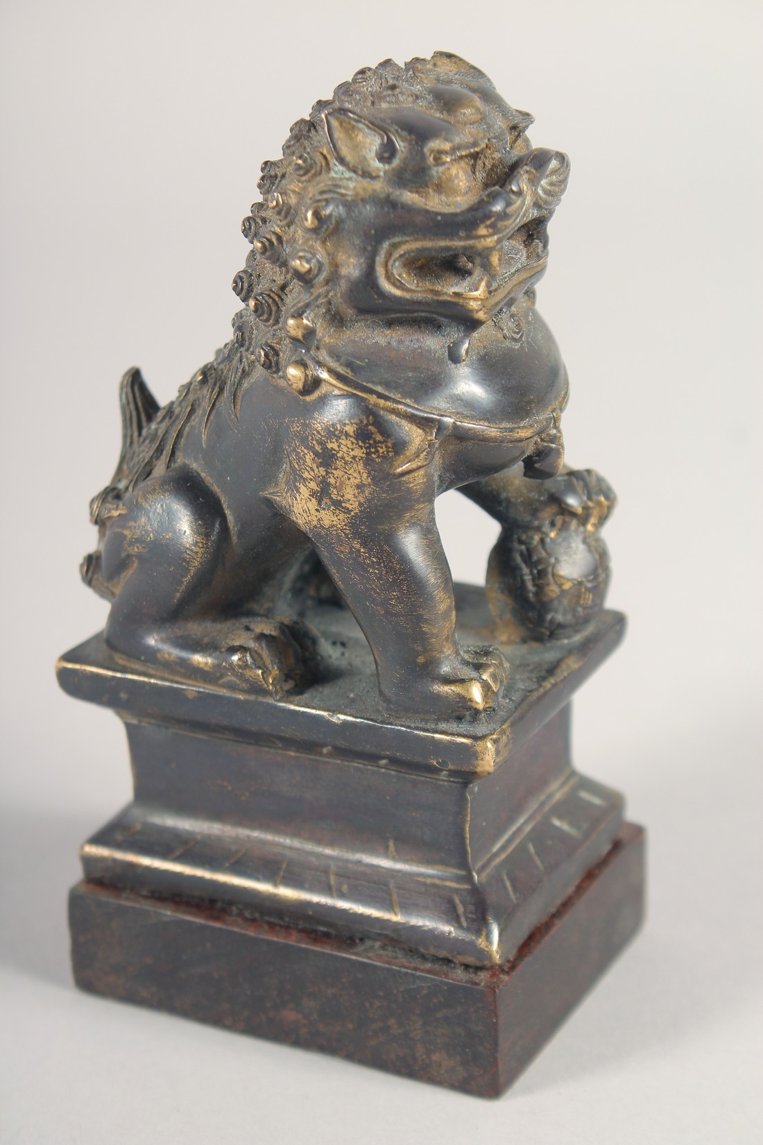 A FINE CHINESE BRONZE LION - possibly Ming, mounted to a wooden base, the figure with traces of - Image 2 of 4