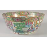 A LARGE CHINESE CANTON FAMILLE ROSE PORCELAIN PUNCH BOWL, painted with panels of figures and further