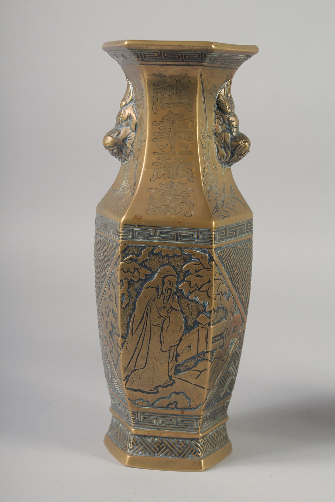 A PAIR OF 19TH CENTURY CHINESE BRONZE HEXAGONAL VASES, engraved with figures and with twin lion - Image 5 of 6