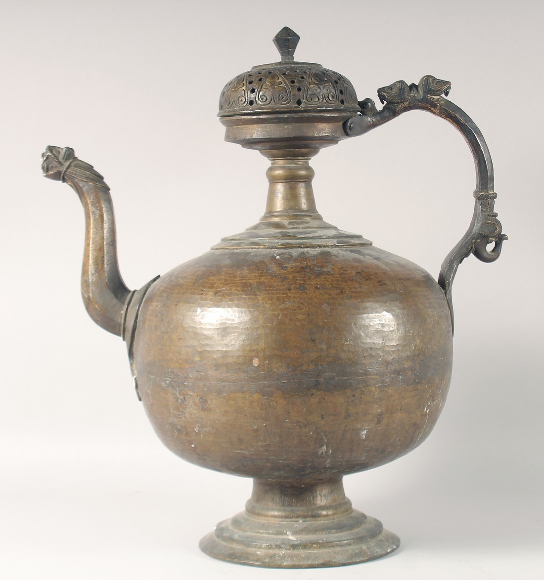 A LARGE 17TH CENTURY INDIAN BRONZE EWER, with zoomorphic handle and spout, 55cm high.