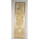 A EARLY 20TH CENTURY JAPANESE DRAGON PANEL, framed and glazed, textile 114cm x 27.5cm.