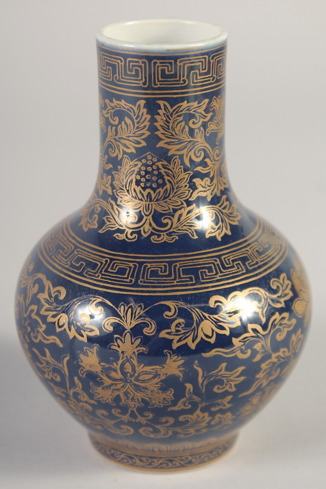 A CHINESE POWDER BLUE VASE, with gilt floral decoration, the base with six-character mark, 13cm