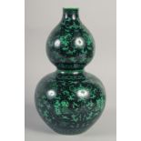 A CHINESE BLACK GROUND DOUBLE GOURD VASE, decorated with peaches, bats and scrolling vine, 31cm