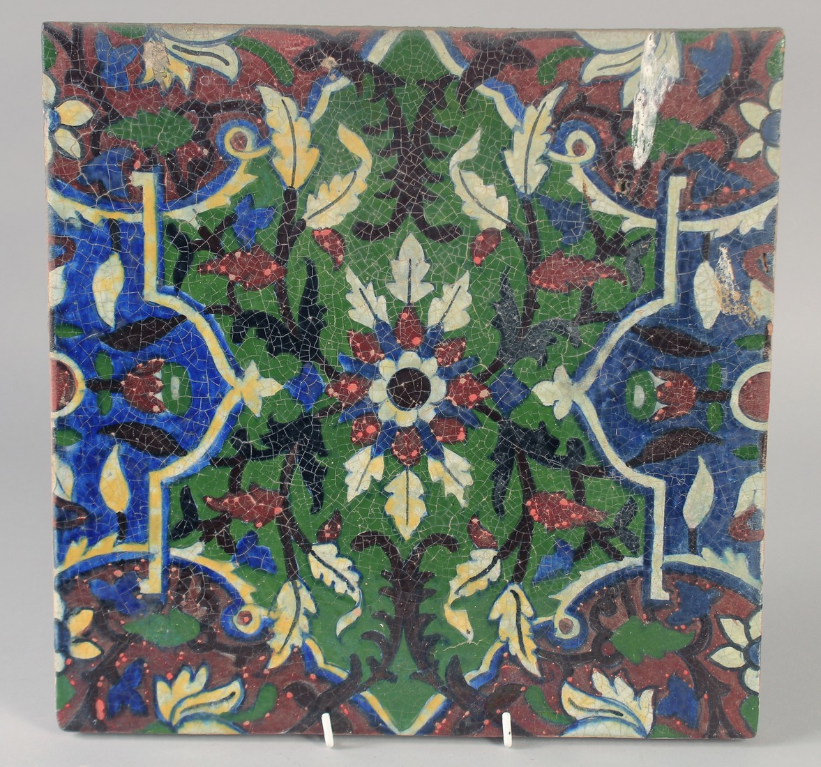 A FINE AND UNUSUAL LARGE 19TH CENTURY INDIAN TILE, with floral motif, 30.5cm square.