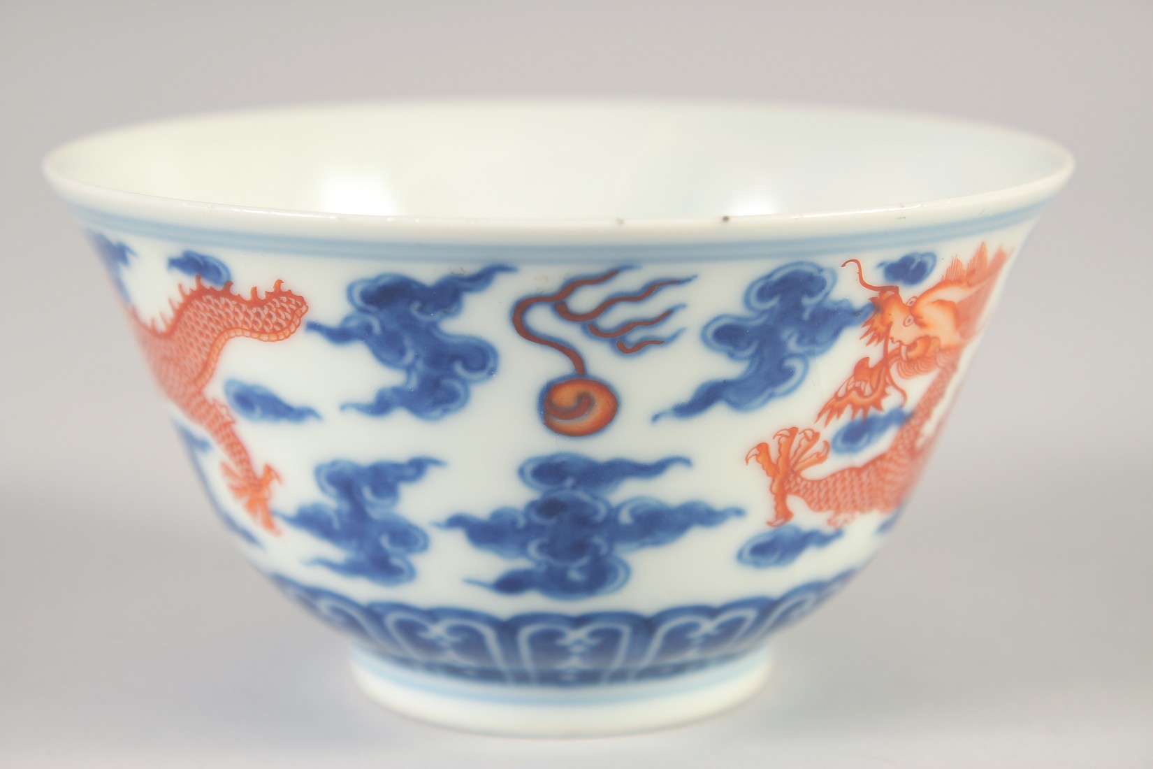 A CHINESE BLUE, WHITE AND IRON RED BOWL, with dragons and stylised clouds, Xuantong mark to base, - Image 4 of 7