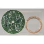 A CHINESE JADE DISK, with calligraphy and lion dogs, together with a hardstone bangle, (2).
