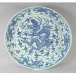 A VERY LARGE CHINESE BLUE AND WHITE PORCELAIN DRAGON DISH, with a large central dragon and the