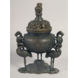 A CHINESE BRONZE CENSER AND COVER, with relief cranes and dragons, 25cm high.