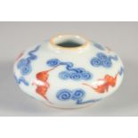 A CHINESE COPPER RED, BLUE AND WHITE PORCELAIN INKWELL, with bats and stylised clouds, 6.5cm