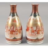 A PAIR OF JAPANESE PORCELAIN SAKE BOTTLES, each with character mark to base, 17cm high.