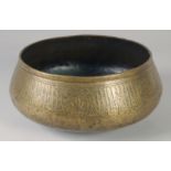 A FINE 14TH CENTURY MAMLUK RASULID BRASS BASIN, with engraved calligraphic panels, 26cm diameter.