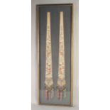 A 19TH CENTURY PAIR OF CHINESE SILK ACCESSORIES, framed and glazed together, frame 113cm x 37cm.