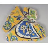 A COLLECTION OF FIVE 17TH CENTURY PERSIAN SAFAVID GLAZED POTTERY TILE FRAGMENTS, with yellow