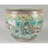 A 19TH CENTURY CHINESE FAMILLE VERTE PORCELAIN JARDINIERE, painted with warriors on horseback and