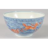 A CHINESE BLUE, WHITE AND CORAL RED PORCELAIN BOWL, painted with carp and various beasts amongst