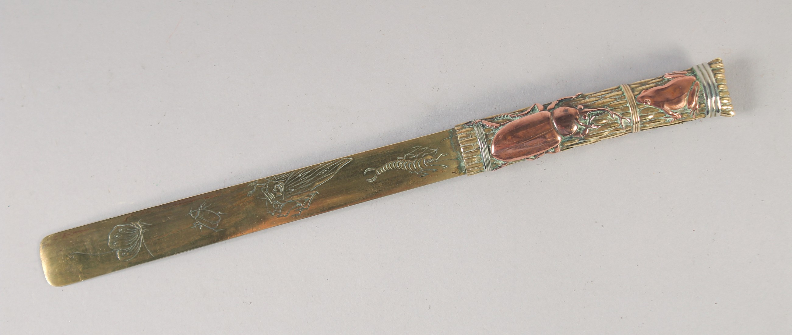 A JAPANESE MEIJI PERIOD SHAKUDO PAGE TURNER, decorated with mixed metals depicting insects and a