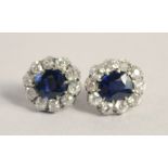 A SUPERB PAIR OF EDWARDIAN NATURAL SAPPHIRE AND DIAMOND SET OVAL CLUSTER EARRINGS.