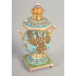 A SMALL RUSSIAN SILVER GILT AND ENAMEL SAMOVAR Mark: 84, 4ins high, 156gms.