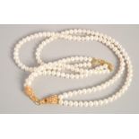 A PEARL NECKLACE with GOLD PLATED PANTHER CLASP.