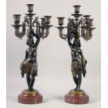 A VERY GOOD PAIR OF BRONZE AND GILDED BRONZE NUBIAN FIGURE FIVE-LIGHT CANDELABRA, each with four