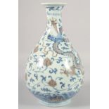 A CHINESE BLUE AND UNDERGLAZE RED PORCELAIN YUHUCHUNPIN VASE, painted with dragon and phoenix